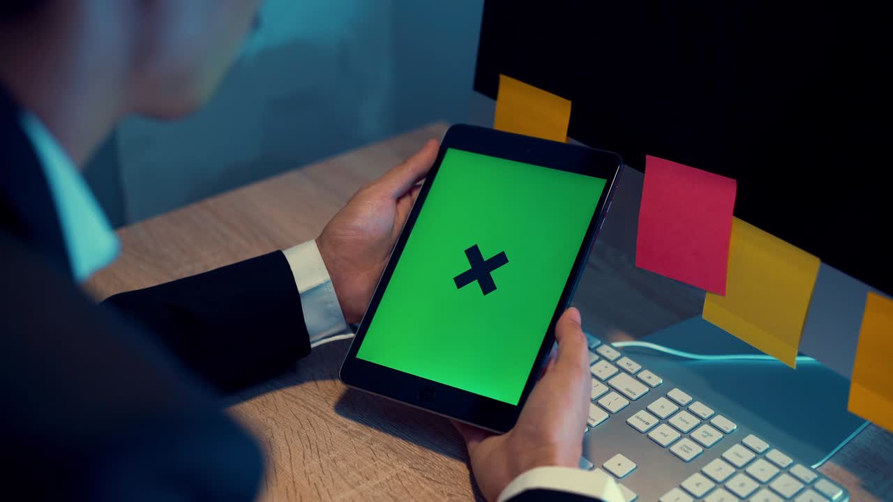 Business man looking tablet green screen