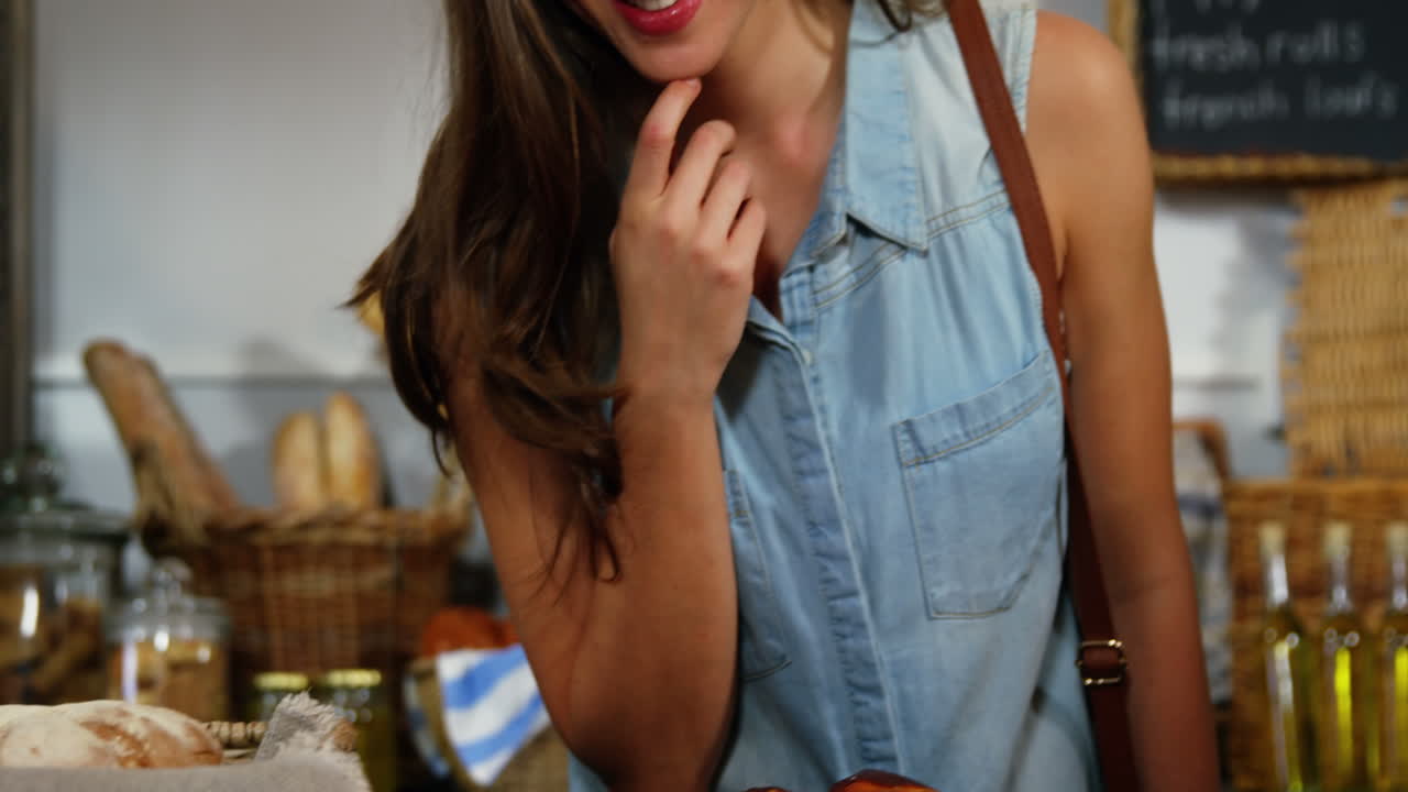 Woman selecting bread at bakery section