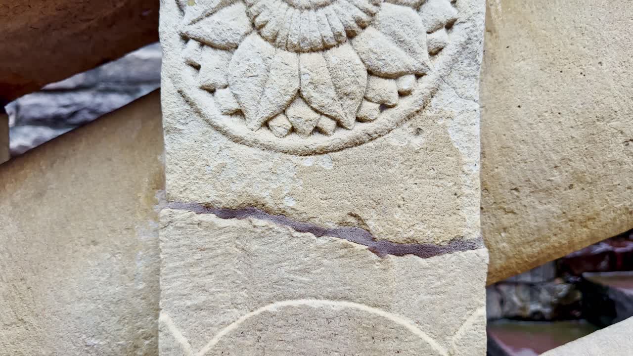 As the camera slowly cranes up, a lotus motif carved in stone at Sanchi emerges, symbolizing purity and enlightenment while reflecting the elegance of ancient Buddhist art and architecture
