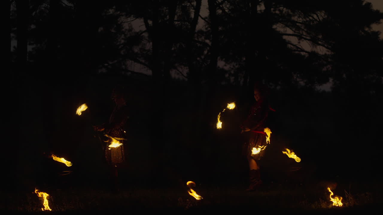Fire Dancers in the Woods at Night