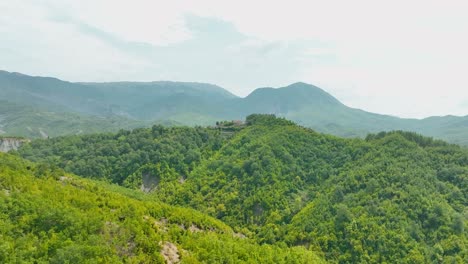 areal shot of mediterranean hilltops with forest and small houses on top