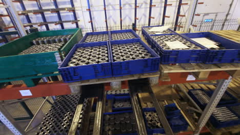 factory forklift truck transporting metal products on warehouse shelves