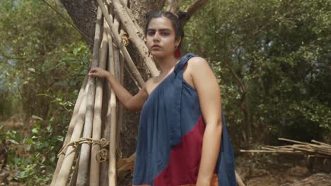 a young indian model of asian descent elegantly showcases her new ensemble during a captivating forest photoshoot