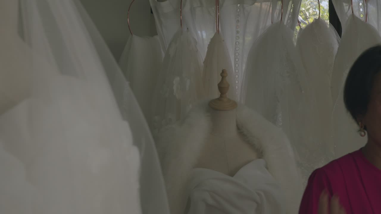 Softly lit bridal store showcases exquisite wedding gowns on mannequins. Delicate lace details and dreamy ambiance enhance romantic setting, perfect for brides-to-be