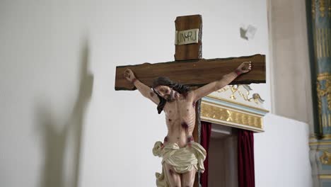 crucifixion statue with &quot;inri&quot; inscription in a church setting