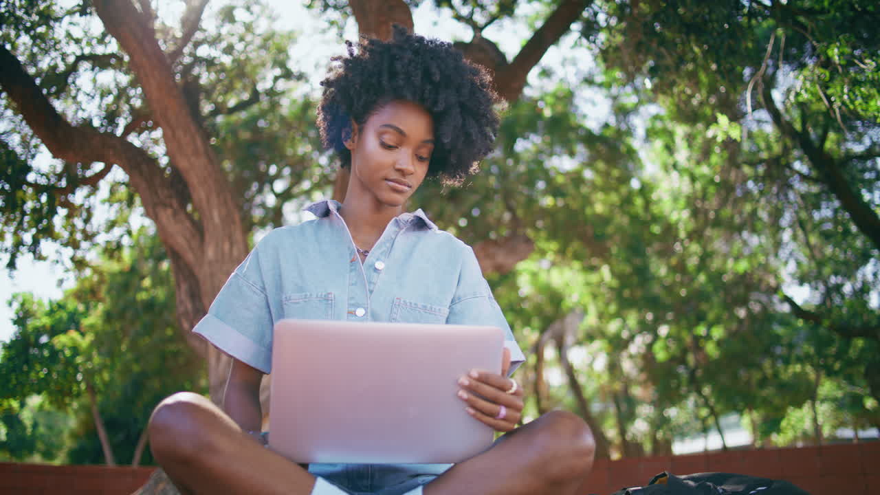 Stylish girl browsing laptop sitting sunny nature closeup.  teenager park