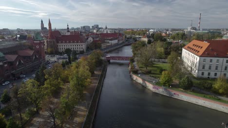 flying over odra river in the historical center of wroclaw city at day time