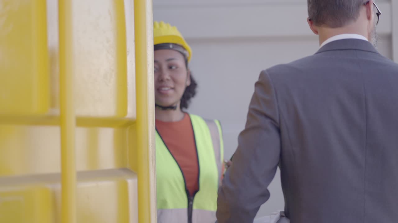 Professional supervisor women and male engineer explain procedure and loading cargo process in the transport system to investor or executive, for information in the decision to expand the business, investment, employment or working together.