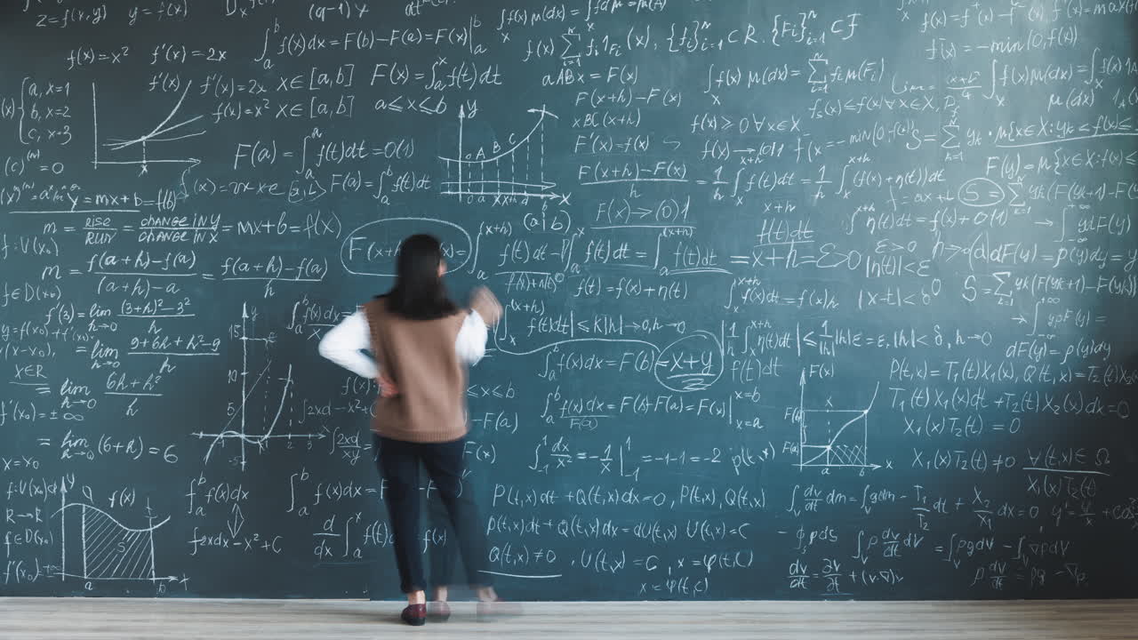 Person walking past a chalkboard covered in complex mathematical equations