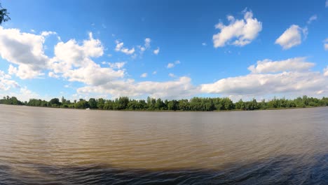 time lapse of tranquil amazon river and clouds in motion against blue sky and sunlight