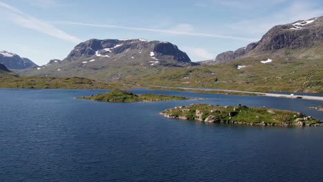 aerial view pushing in over a series of small islands in a fjord in norway