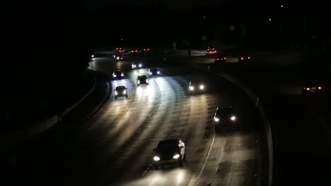 erratic movement shot of cars on the freeway at night