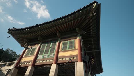 Bongeunsa-Temple---Clouds-time-lapse-over-Ancient-Korean-traditional-Pagoda-Building-with-tiled-roof-and-colorful-woodblock-carvings-standing-on-concrete-columns