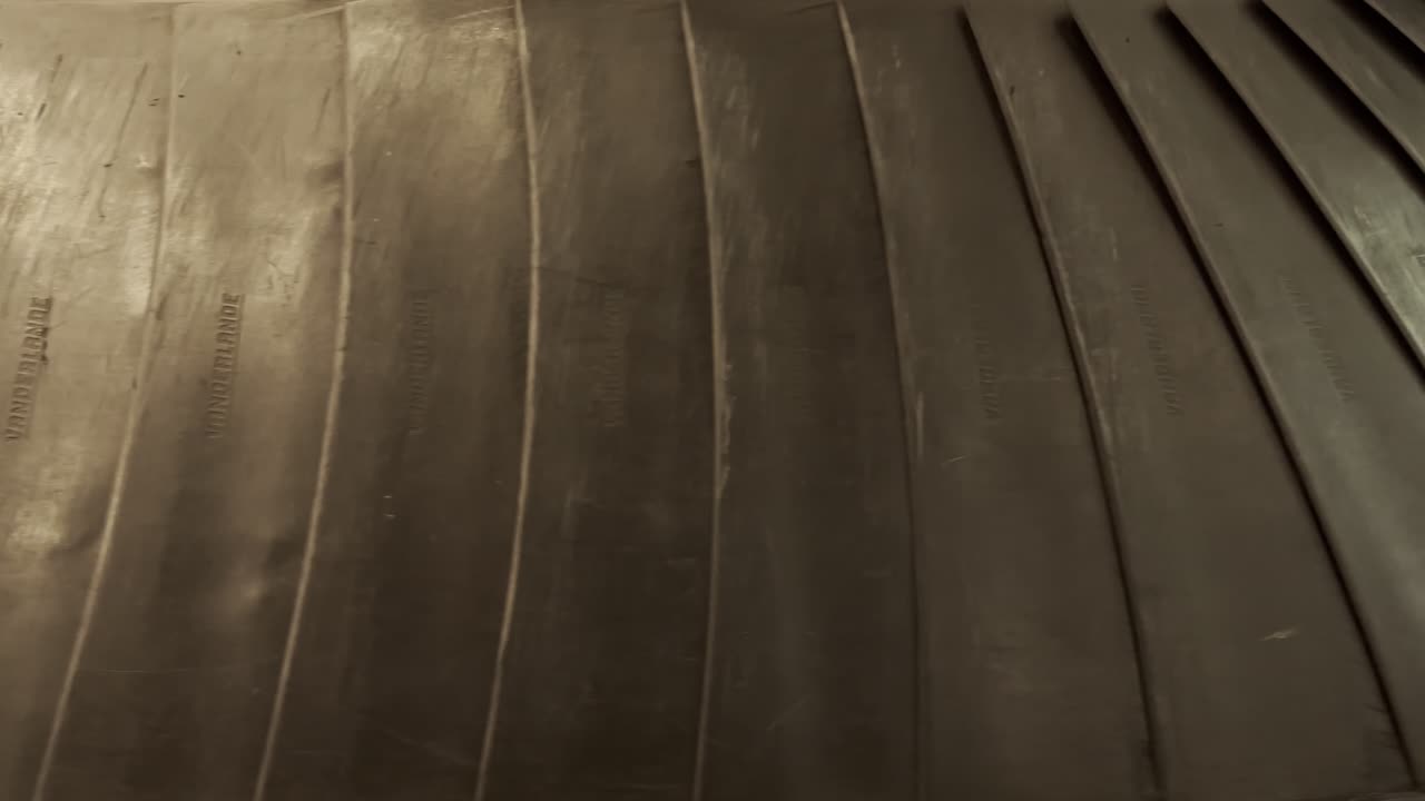 bags and suitcases move along conveyor belt in the baggage reclaim hall at the airport