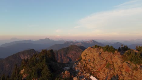 4K-Sunset-Aerial-Drone-Rising-Shot-Over-Deeks-Mountain-Rocky-Landscape-with-Blue-and-Orange-Sky-in-Pacific-Ranges-Canada