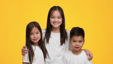 three children smiling together