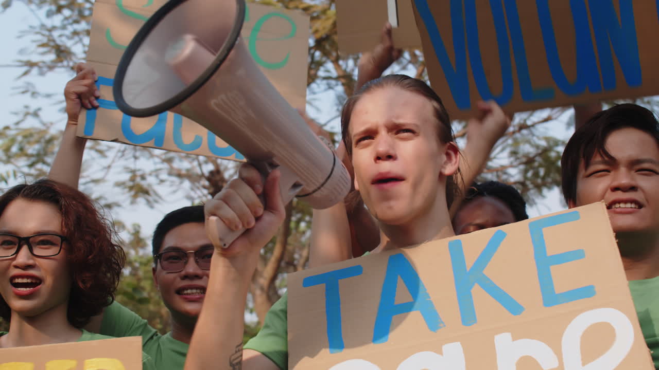 Volunteers Calling to Save Our Planet with Loudspeaker and Placards