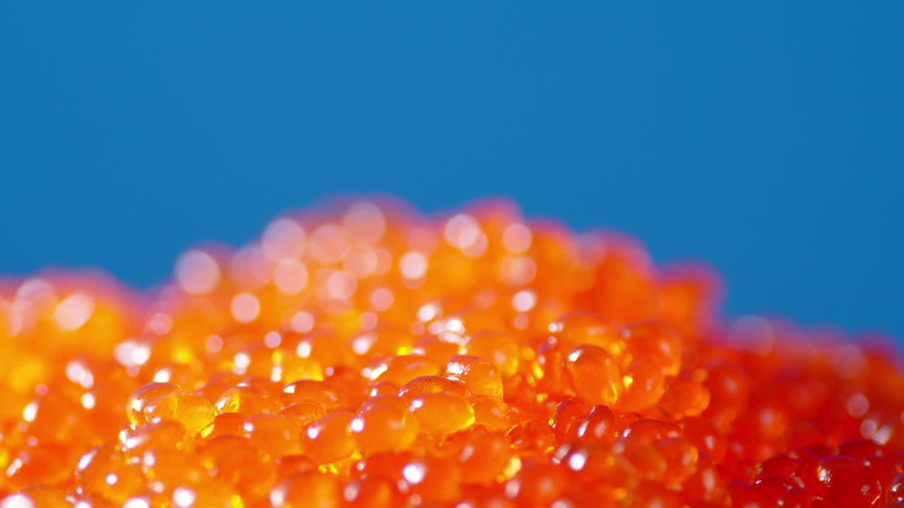 A pile of red caviar is rotating slowly.