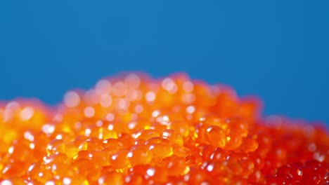 a pile of red caviar is rotating slowly.