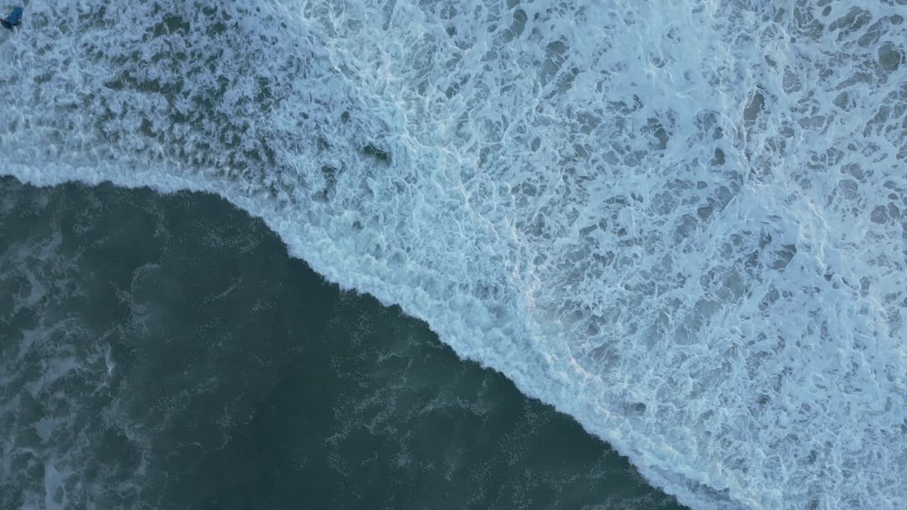 Peaceful ocean waves at sunset from above in California