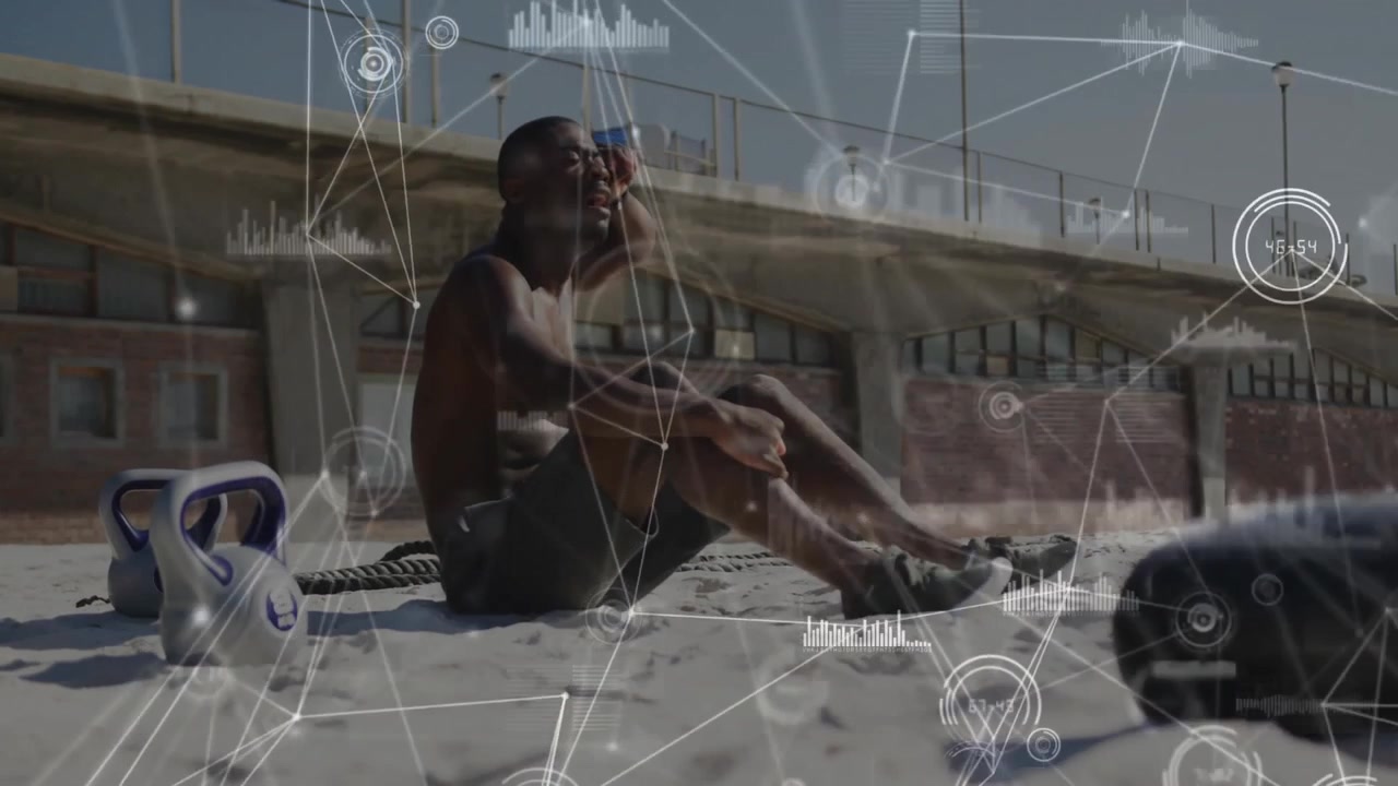 Mid adult male athlete recovering breath after rope workout on beach with health graph overlaying