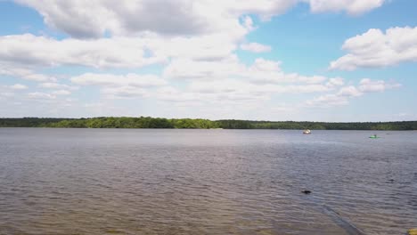 Aerial-rising-shot-of-Watchaug-pond-in-Burlingame-State-Park,-Charlestown