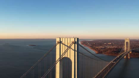 aerial view away from the verrazzano-narrows bridge, golden hour in new york, usa - reverse, drone shot