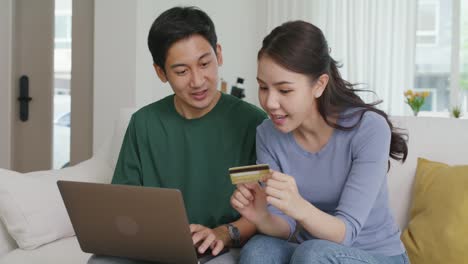 happy asian man and woman booking ticket online app from retail store.