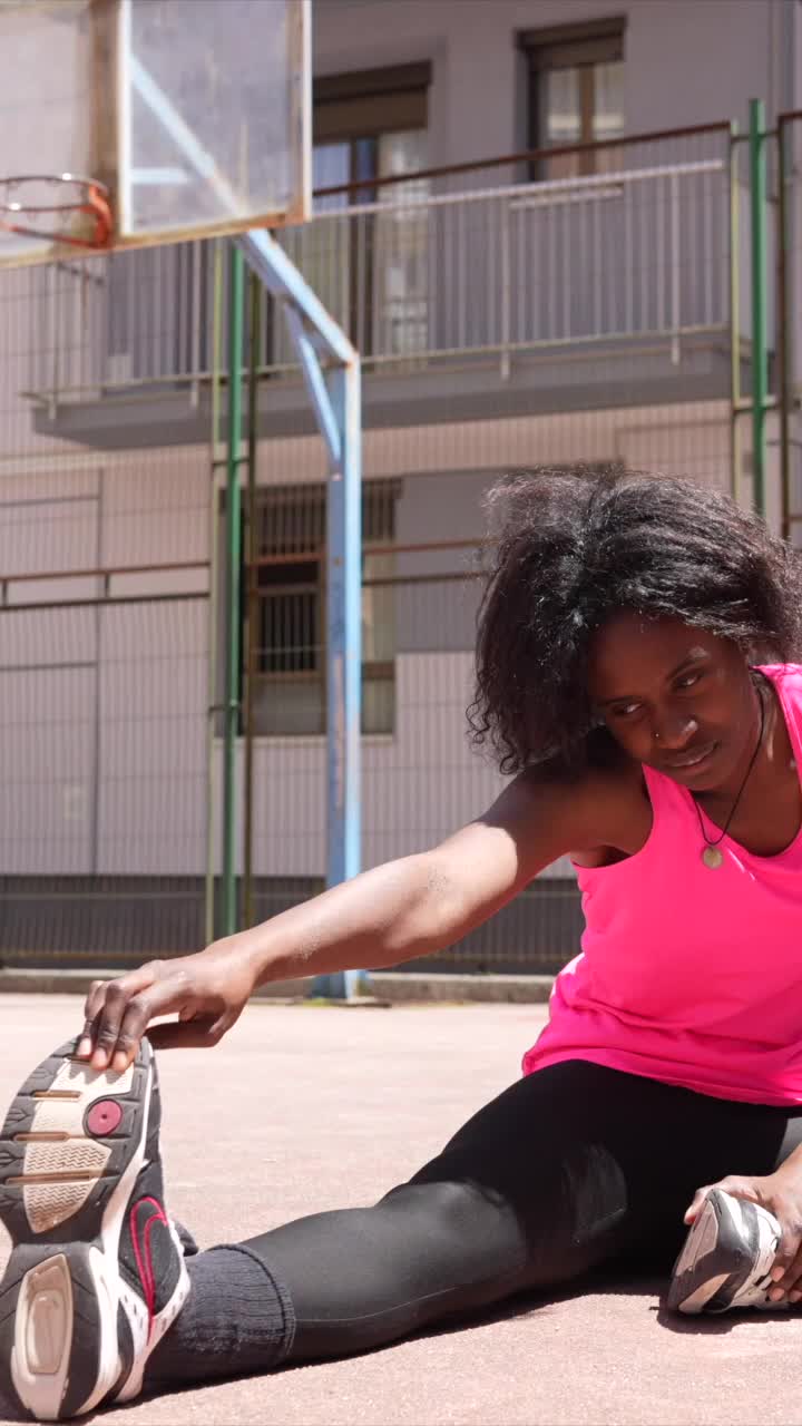 Woman Stretching on Basketball Court