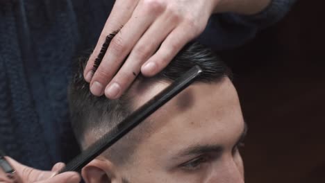 man getting a professional haircut at a barbershop