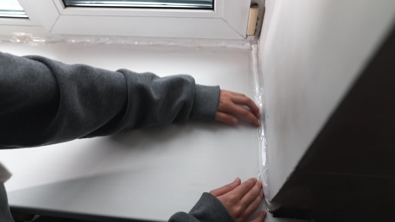Applying Window Insulation Tape
