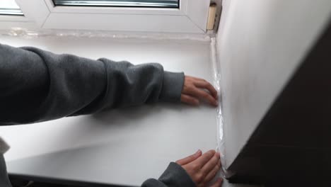 applying window insulation tape