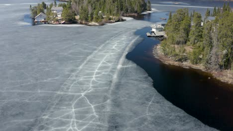 dolly forward of melting ice around rural canadian cottage