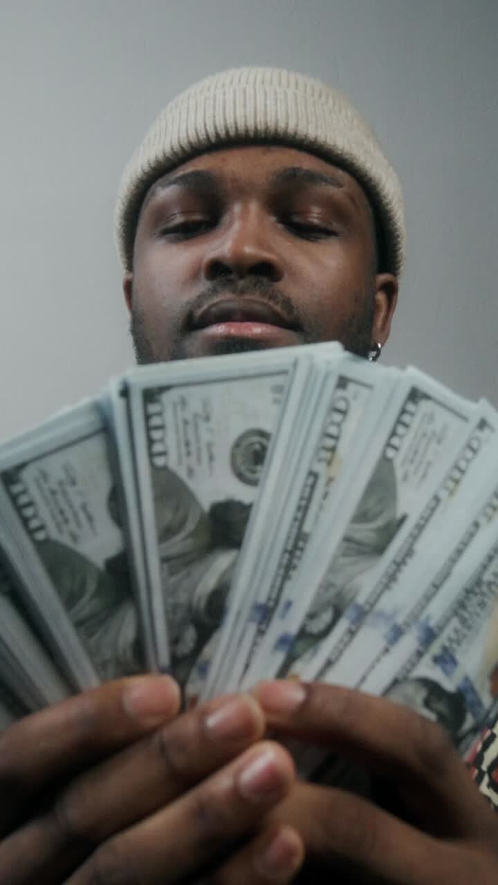 Man Holding Stacks of Money