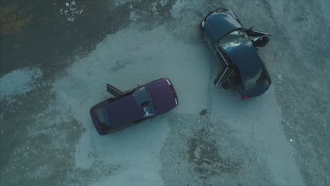 damaged cars on dirt lot