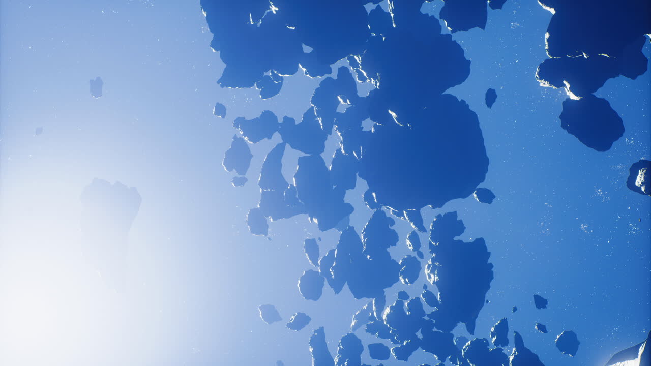 신비한 바위 형태가 빛을 받으며 깊은 파란 공간에서 떠다니고 있습니다.