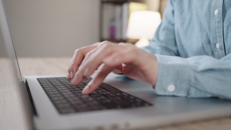 Close up Shot of Businesswoman hands typing on laptop computer keyboard for searching information,online communication support,marketing research,business report in the office desk at night.