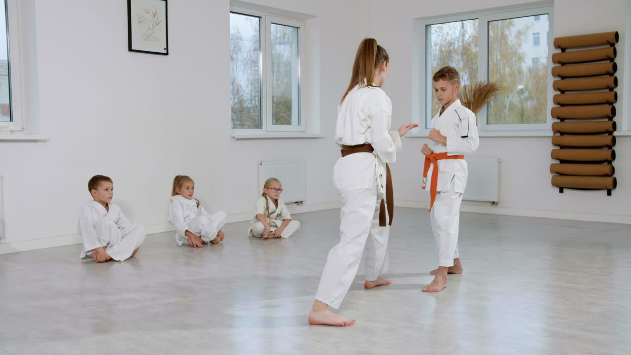 Kids in white kimono in martial arts class