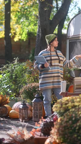 woman studying outside a camper in autumn