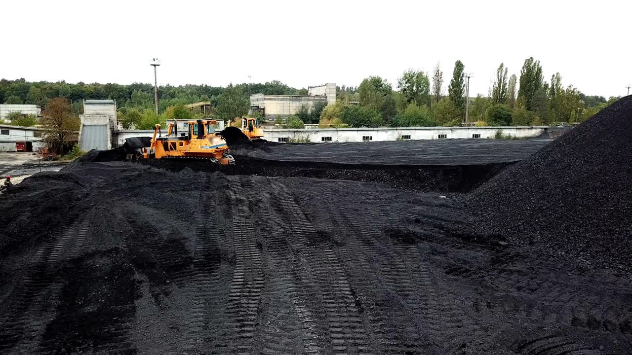 Open pit mine, breed sorting. Mining coal. Bulldozer sorts coal. Extractive industry, anthracite. Coal industry.