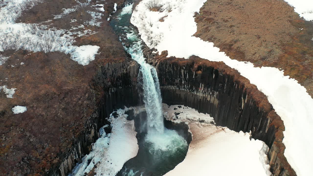 Stunning Landscape Of Svartifoss Waterfall Cascading On The River In South Iceland.  - aerial drone ascending