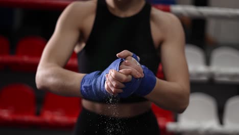 Woman-Dusting-Powder-On-Her-Hands-Wrapped-In-Boxing-Tapes-And-Clapping-Hands