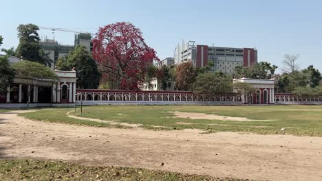 pan shot of patna university on weekend afternoon with long sports field in front.