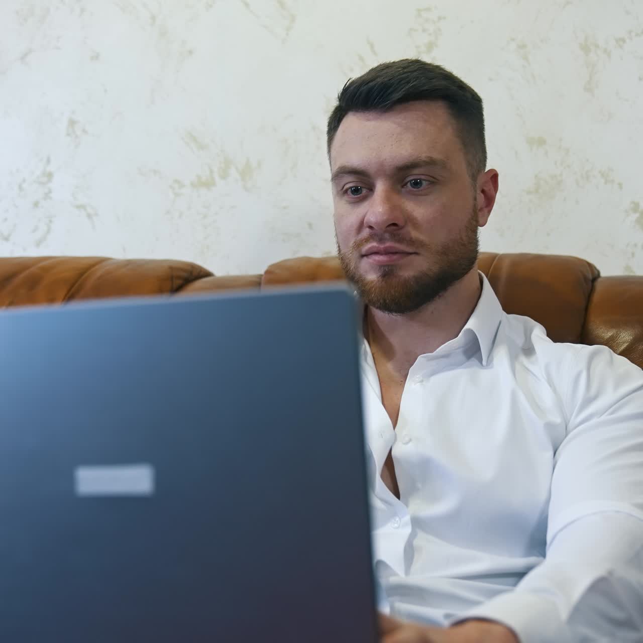 Businessman using smart phone and laptop at hotel room