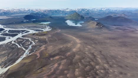 snowy peaks of icelandic highlands and mountains in summer. aerial wide shot. panorama view of volcanic landscape