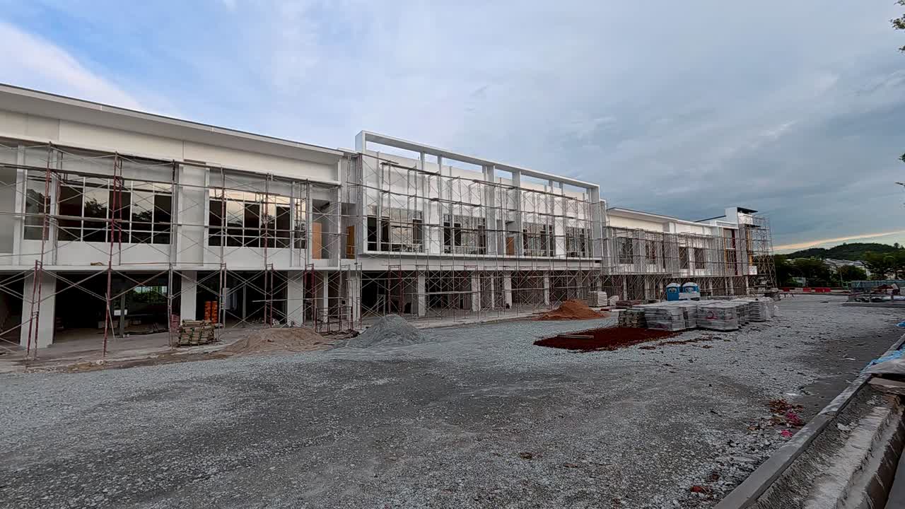 A newly built two-story shop lot in the final stage of construction with modern design, wide facade, and spacious road infrastructure.