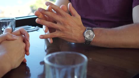 Young-couple-on-a-date-talking-in-restaurant---cafe---bar---CLOSE-UP-of-hands