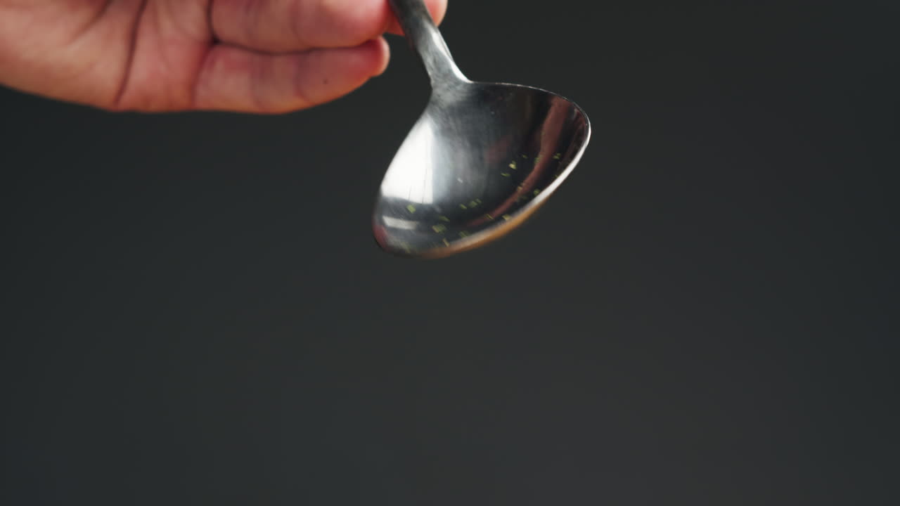 Dried red hot spicy chilli pepper on spoon close-up macro. Spice for food. Dried vegetable.High quality 4k footage