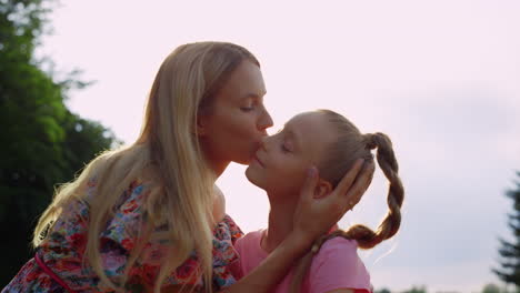 Smiling-mother-and-daughter-enjoying-together-in-city-park