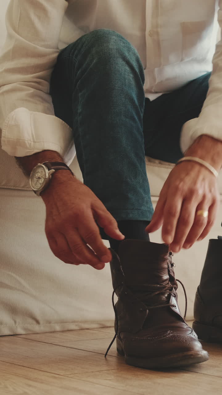 Man Lacing Up Brown Leather Boots